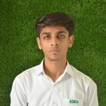 This image shows a picture of a young boy named Shaaf Kashif, the house captain of Artemis, in his Eden college white uniform against a green turf background.