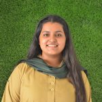 This image shows a smiling picture of Seerat Fatima, the House captain of Hades, in her Eden College Khaki uniform against a green turf background.